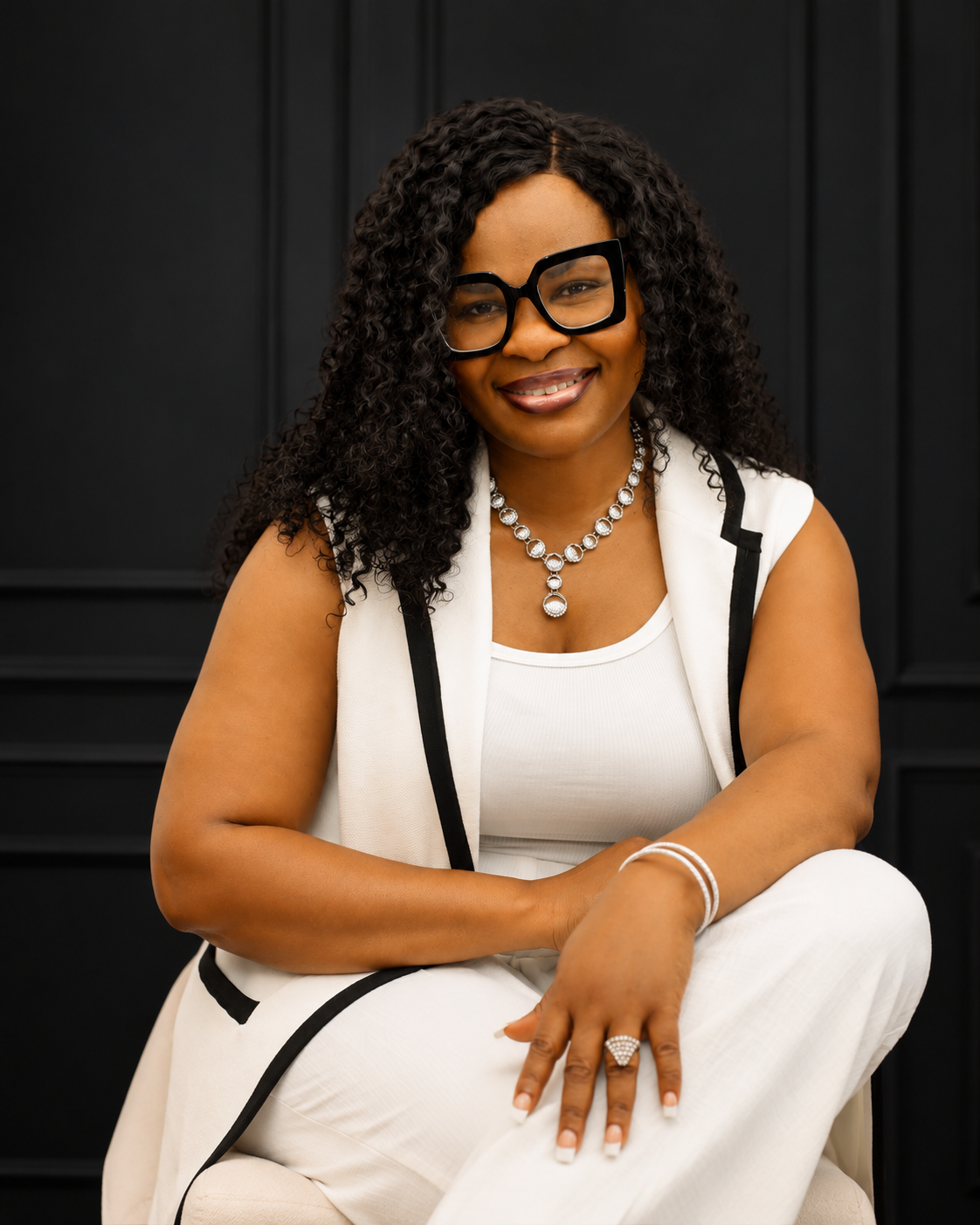 Dr. Tessy Aguzie seated, founder of The Resilience Architect™