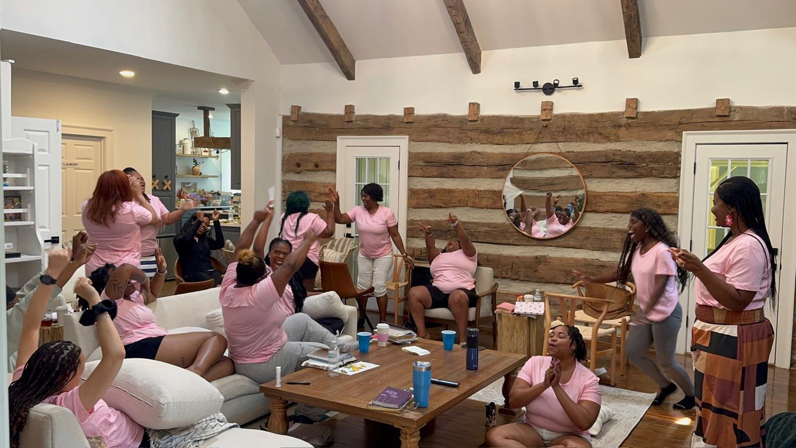 Women celebrating with joy at the R.I.S.E. Women's Retreat