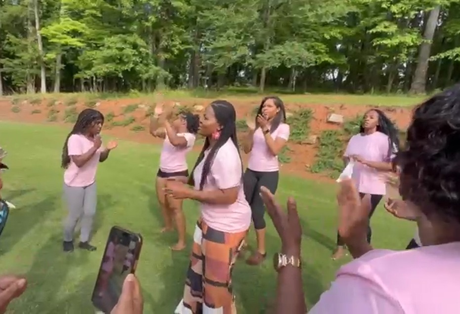 Women worshipping together outdoors on the lawn at the R.I.S.E. Women's Retreat