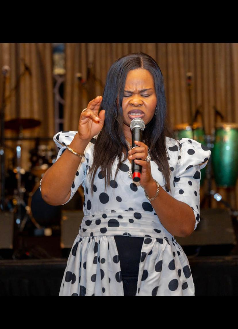 Dr. Tessy Aguzie speaking live into a microphone