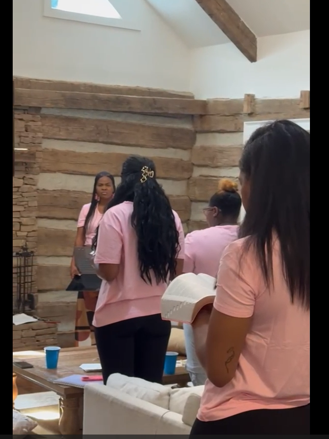 Women standing with the Word open during a R.I.S.E. retreat session